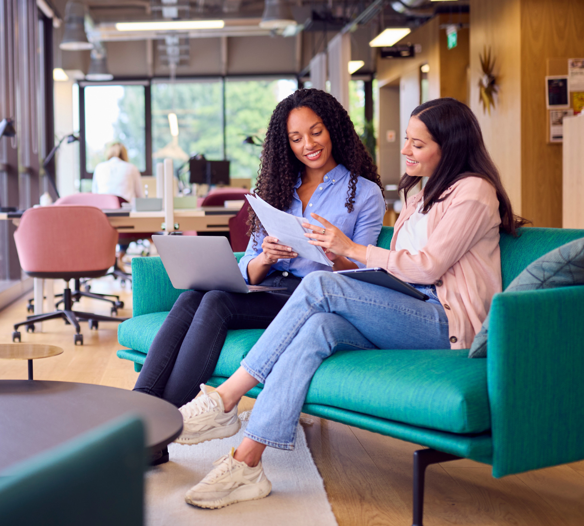 Image of Two Women Seated discussing Work